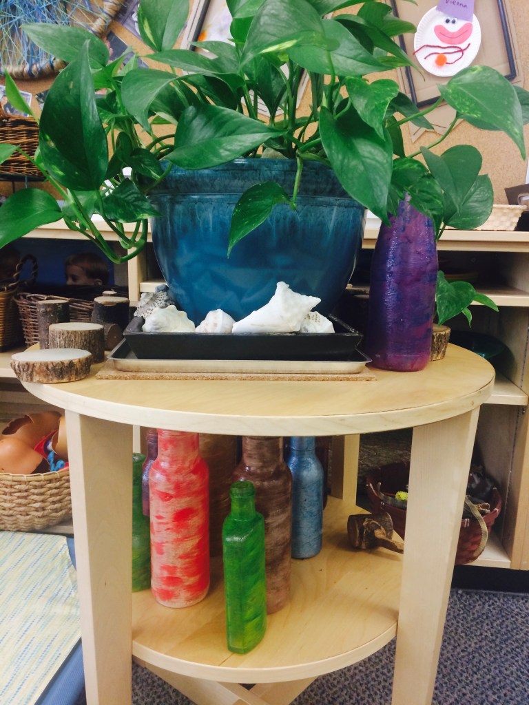 Their collection of glass bottles and plants help to make the learning space interesting and calm!